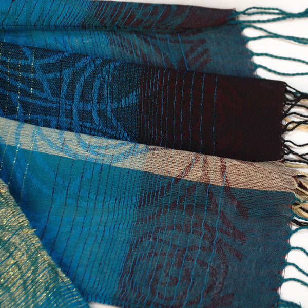 Teal and dark maroon woven border with fringe tassels along the shawl edge