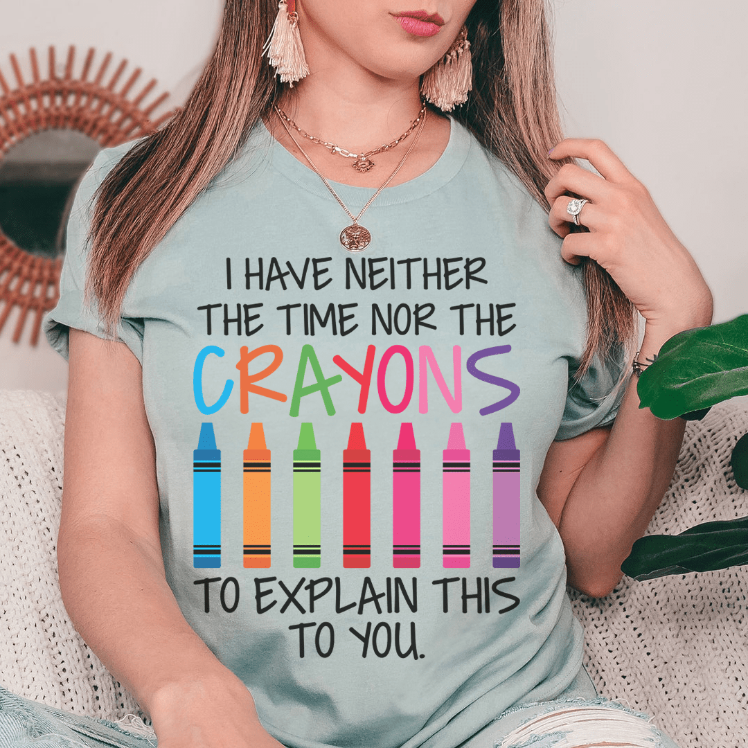 Light blue crewneck T-shirt with colorful crayon illustration and text 'Crayons' in large letters