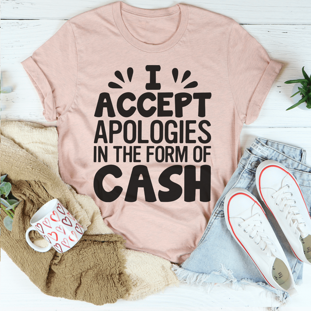 Mauve T-shirt with bold text: "ACCEPT APOLOGIES IN THE FORM OF CASH"