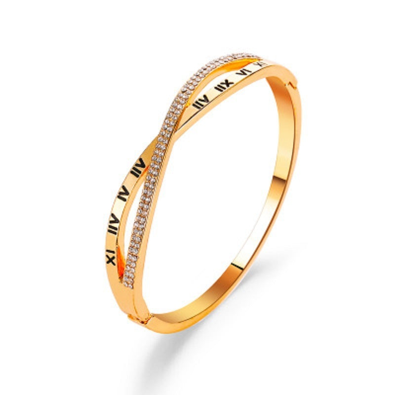 Gold-tone roman numeral bracelet bangle with rhinestone pave strip and etched numbers