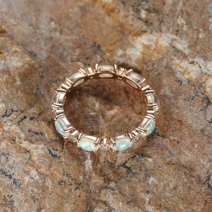 Front view gold-tone opal bezel ring with round opal stones and small clear accents