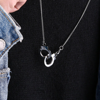 Handcuff pendant necklace with silver handcuff charm and looped chain, close-up