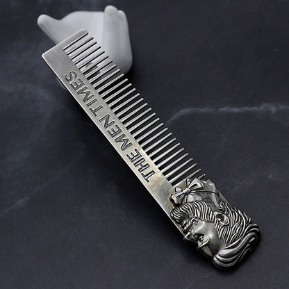 Stainless steel comb with fine teeth, lion-face handle and engraved lettering on bar