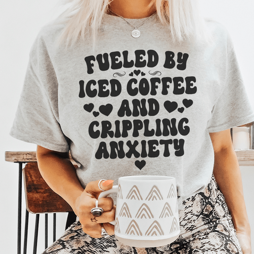 Heather gray crew T-shirt with black slogan graphic and hearts, holding a mug.