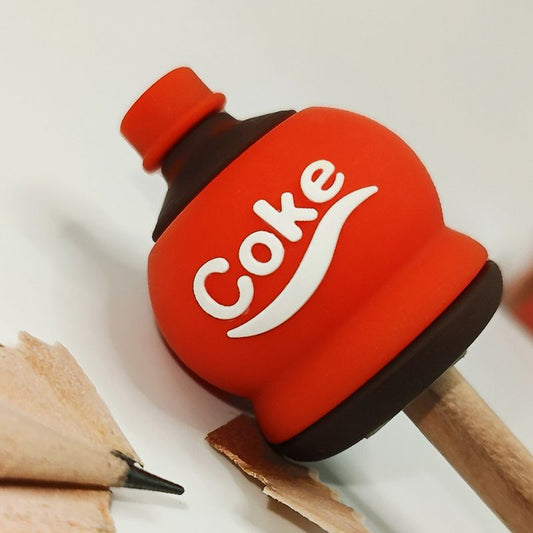 Red Coke-shaped plastic pencil sharpener with black base and pencil shavings opening