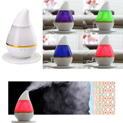 Aromatherapy humidifier set with white base and colored glowing tops: purple, blue, green, red