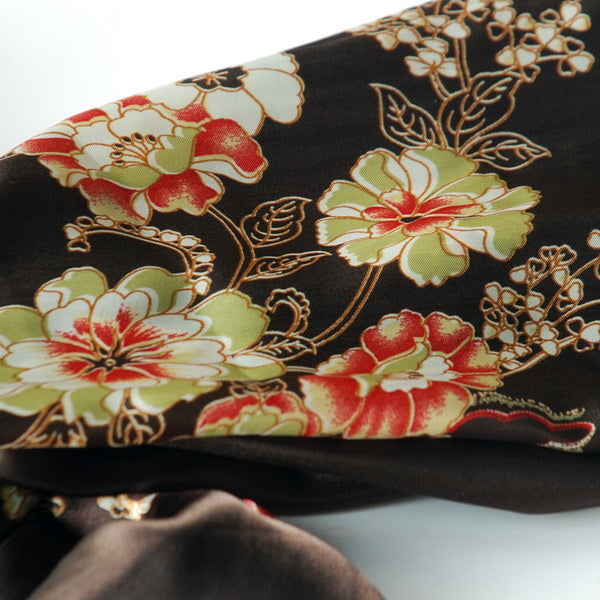 Silk scarf close-up: dark brown fabric with multicolor floral and gold vine embroidery
