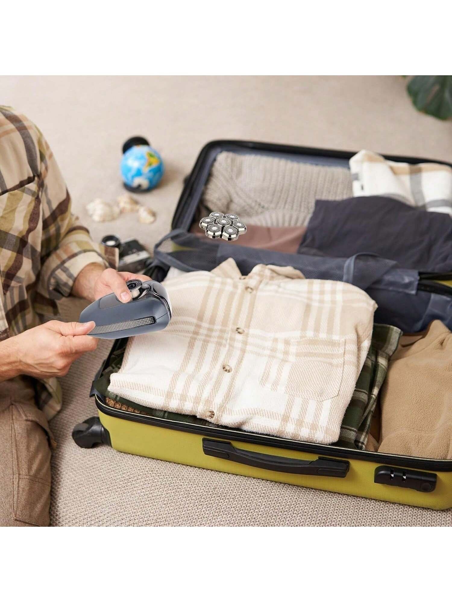 Electric shaver resting in a portable travel case with grooming accessories inside