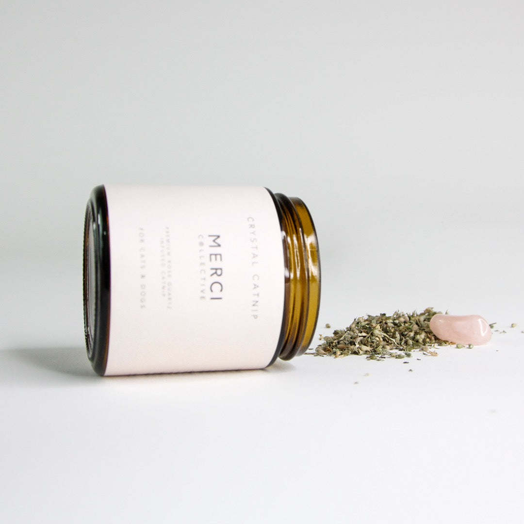 Crystal catnip jar tipped with loose catnip and pink rose quartz