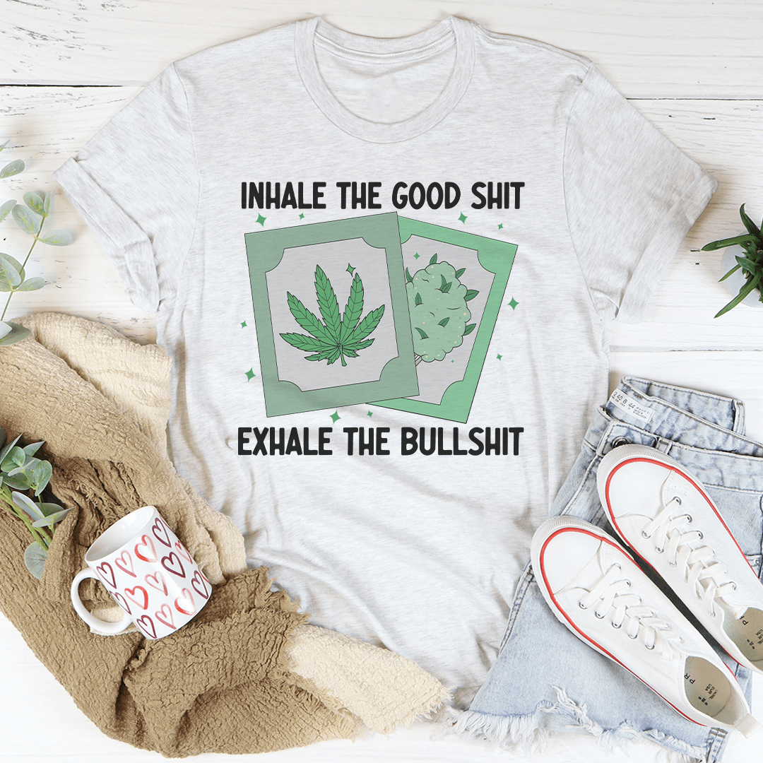 Light gray crewneck T-shirt, centered front graphic of green leaf panels with quote text