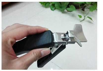 Hot pot picker with dark handle and silver metal prongs, cool-touch grip
