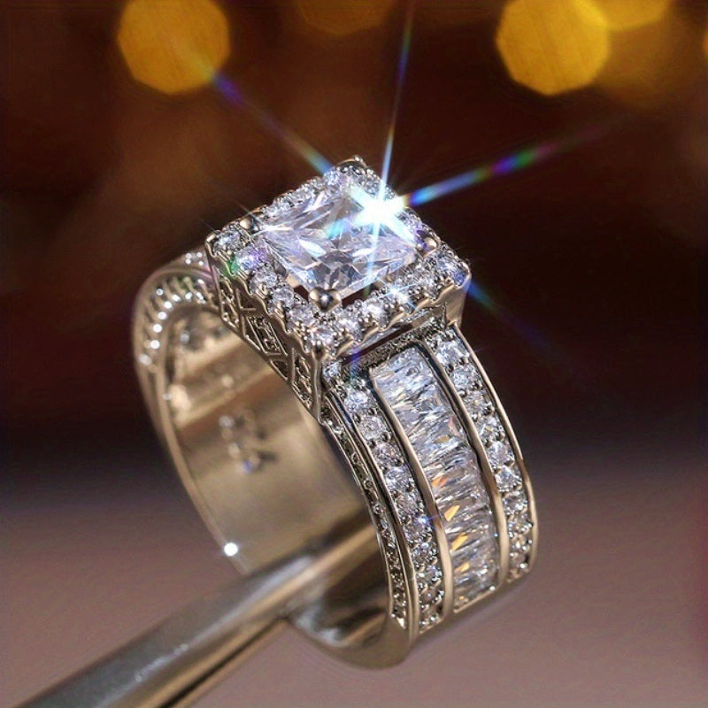 Square-cut halo zircon ring with silver pavé stones and raised center