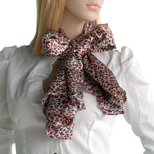 Leopard-print silk scarf tied at neck, orange, black, and cream tones