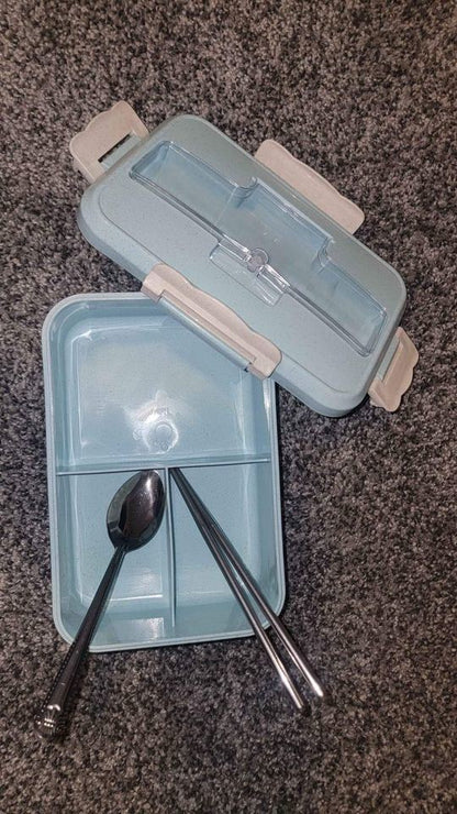 Blue bento box open with two compartments and utensil set