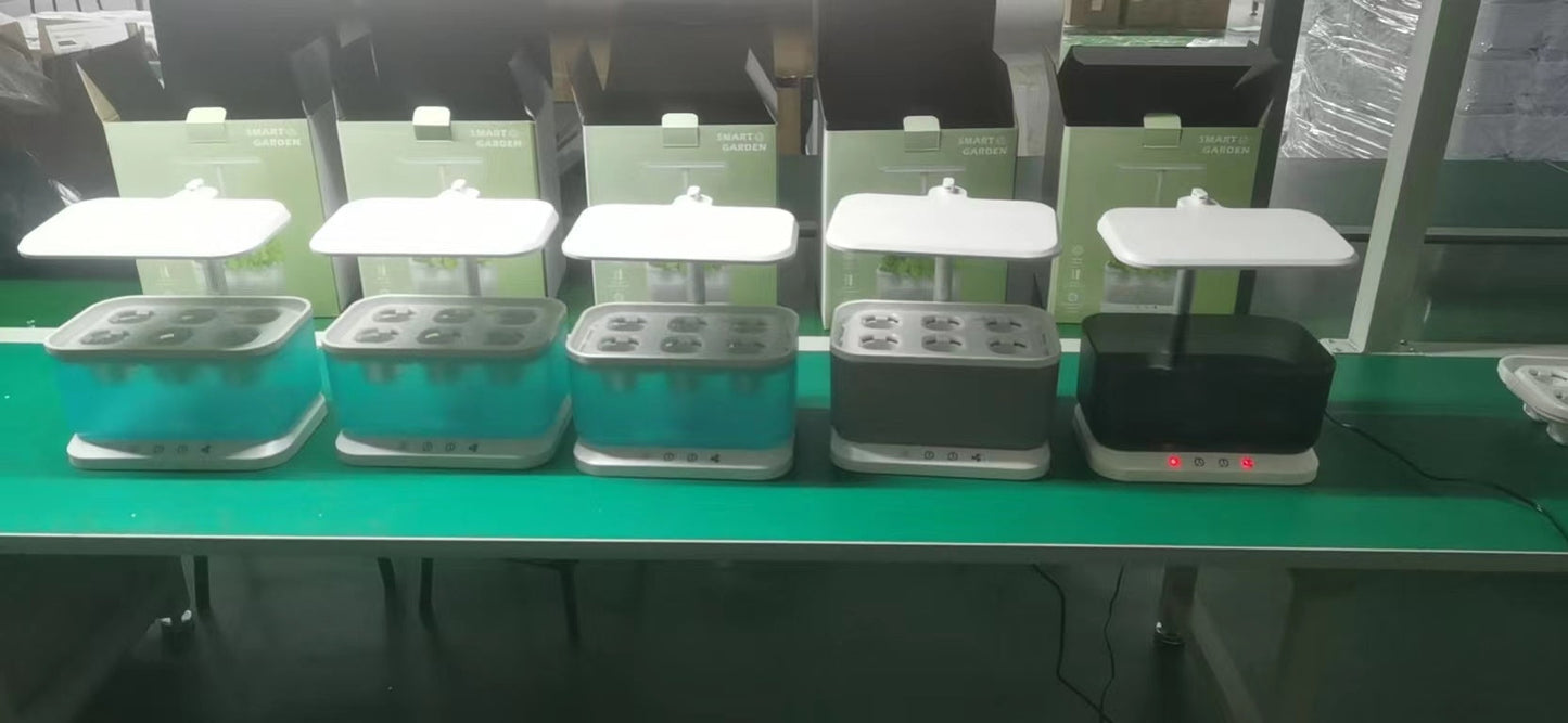 Row of indoor hydroponics systems with LED grow lights and colored reservoirs