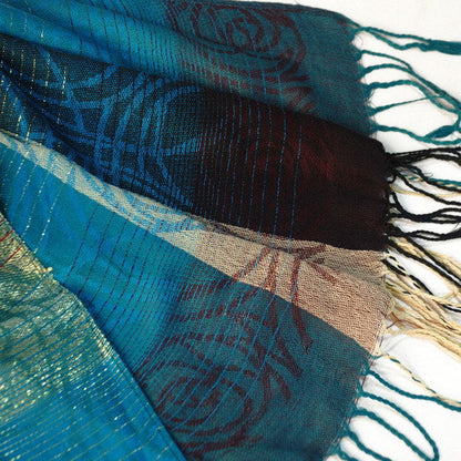 Close-up of tassel ends on teal and burgundy plaid pashmina shawl with fringes