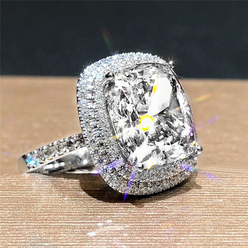 Silver bridal ring with large clear cubic zirconia and halo of pavé stones