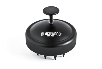 Black scalp massager with BLACKWOOD logo on domed head