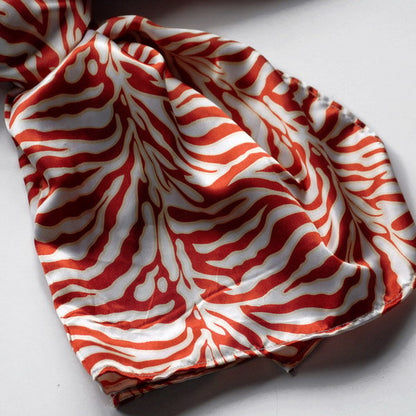 Close-up of red and white zebra-striped silk scarf with soft folds