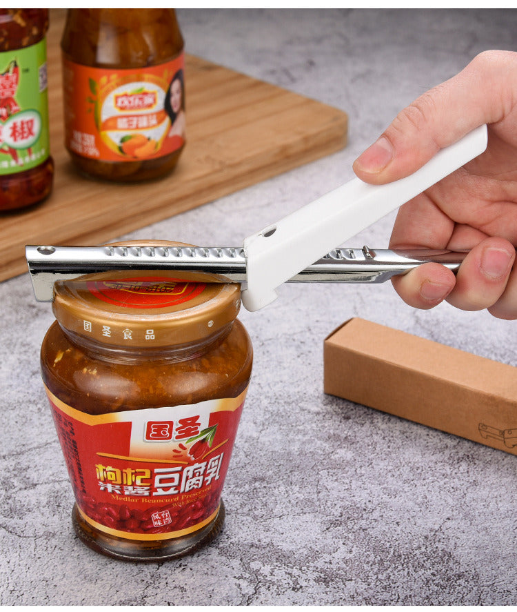 Jar lid opener gripper with white handle and serrated edge, held in hand.