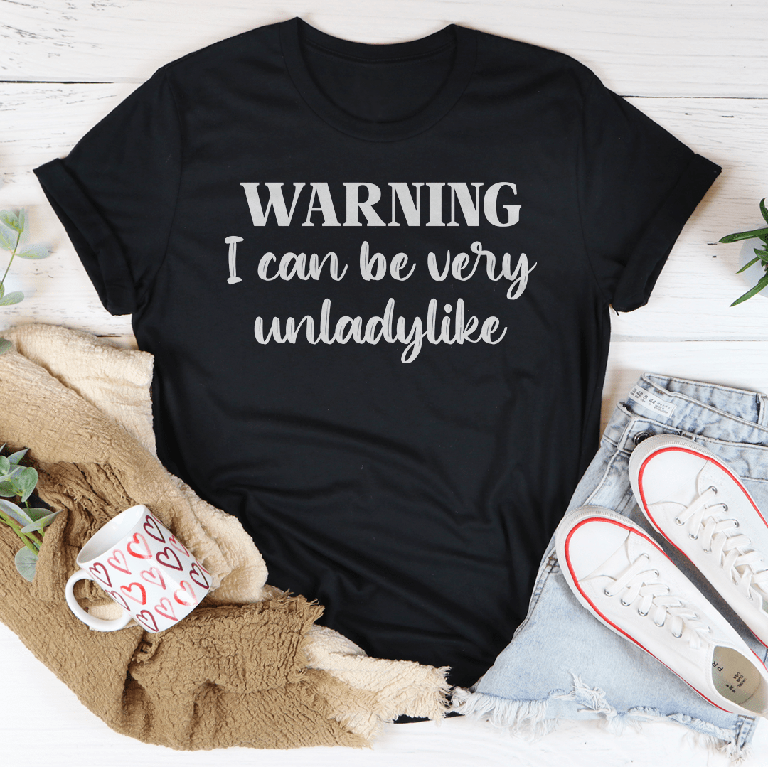 Black unisex T-shirt with 'WARNING I can be very unladylike' front graphic