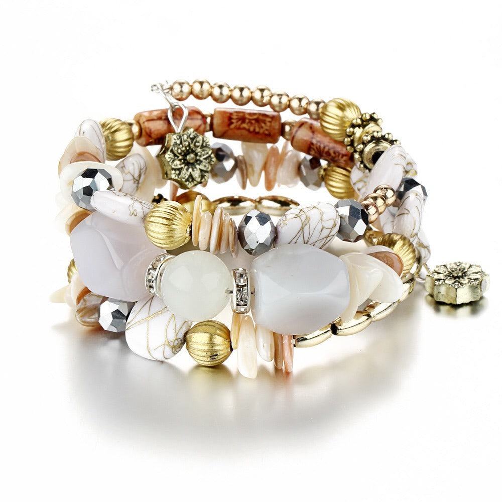 Multilayer beaded charm bracelet with white stones, gold beads, and crystal accents