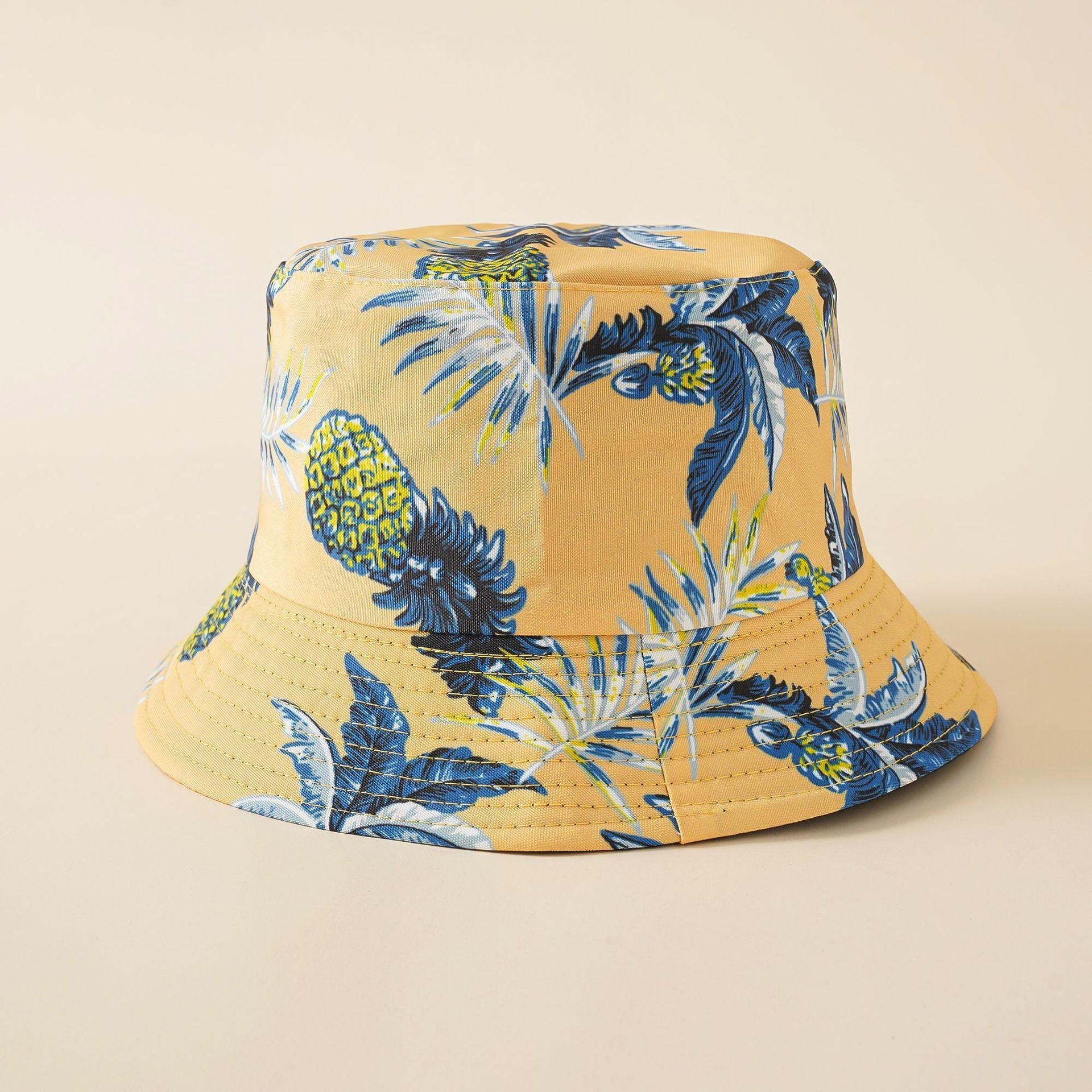 Mustard-yellow tropical fisherman bucket hat with blue pineapple and tropical leaves