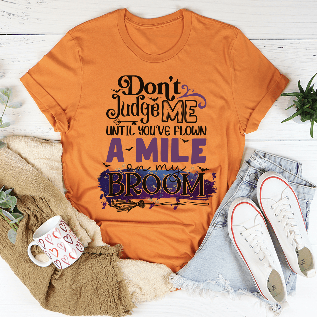 Burnt orange crewneck T-shirt with bold purple broom design and slogan text