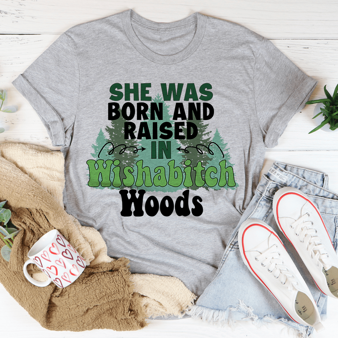 Gray T-shirt with 'She was born and raised in Wishabitch Woods' graphic