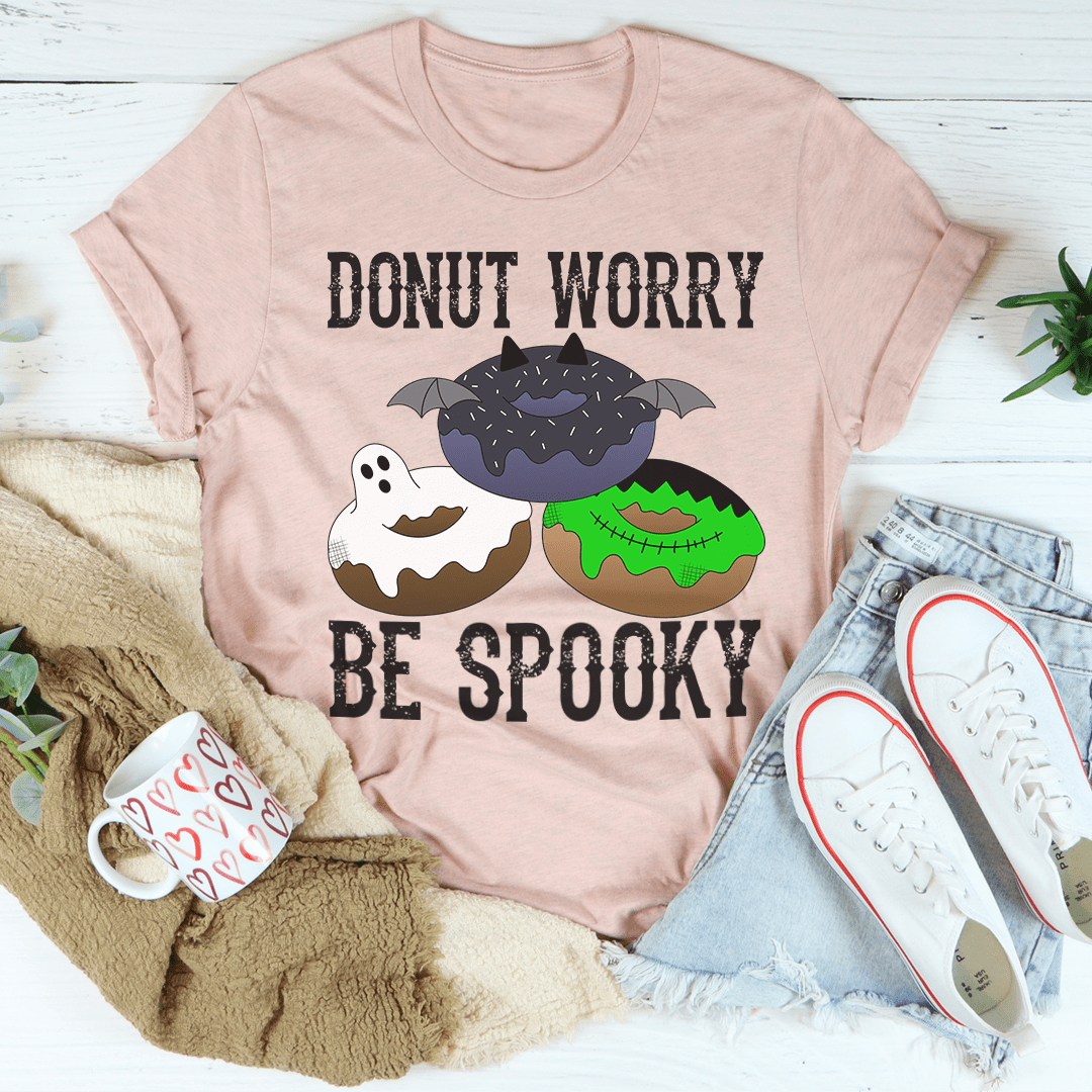 Light pink crew-neck T-shirt with donut and bat graphic, Donut Worry Be Spooky.