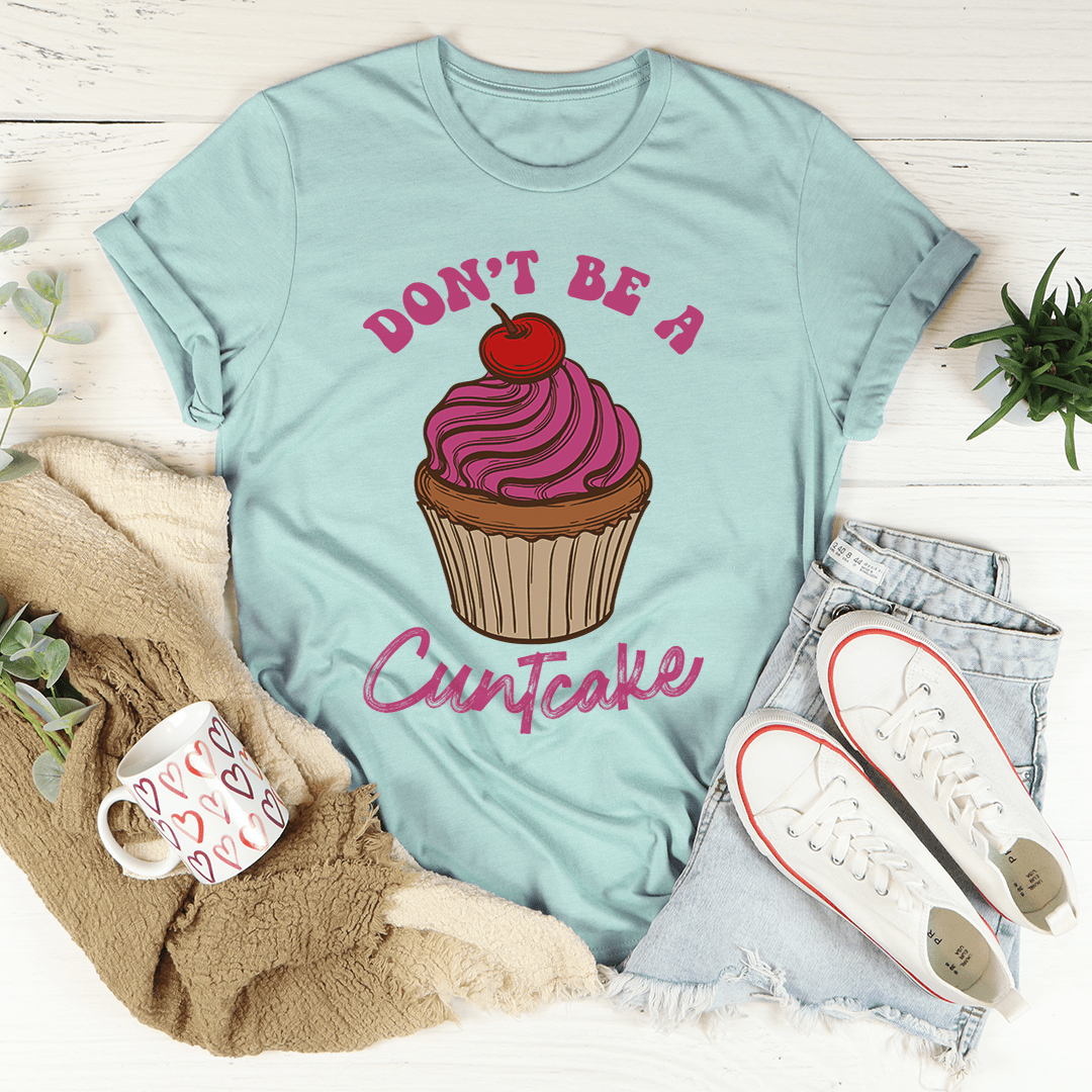 Teal T-shirt featuring a pink-and-purple cupcake illustration and 'Cuntcake' lettering