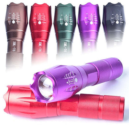Purple zoomable focusing flashlight with front lens, mode buttons, and knurled grip