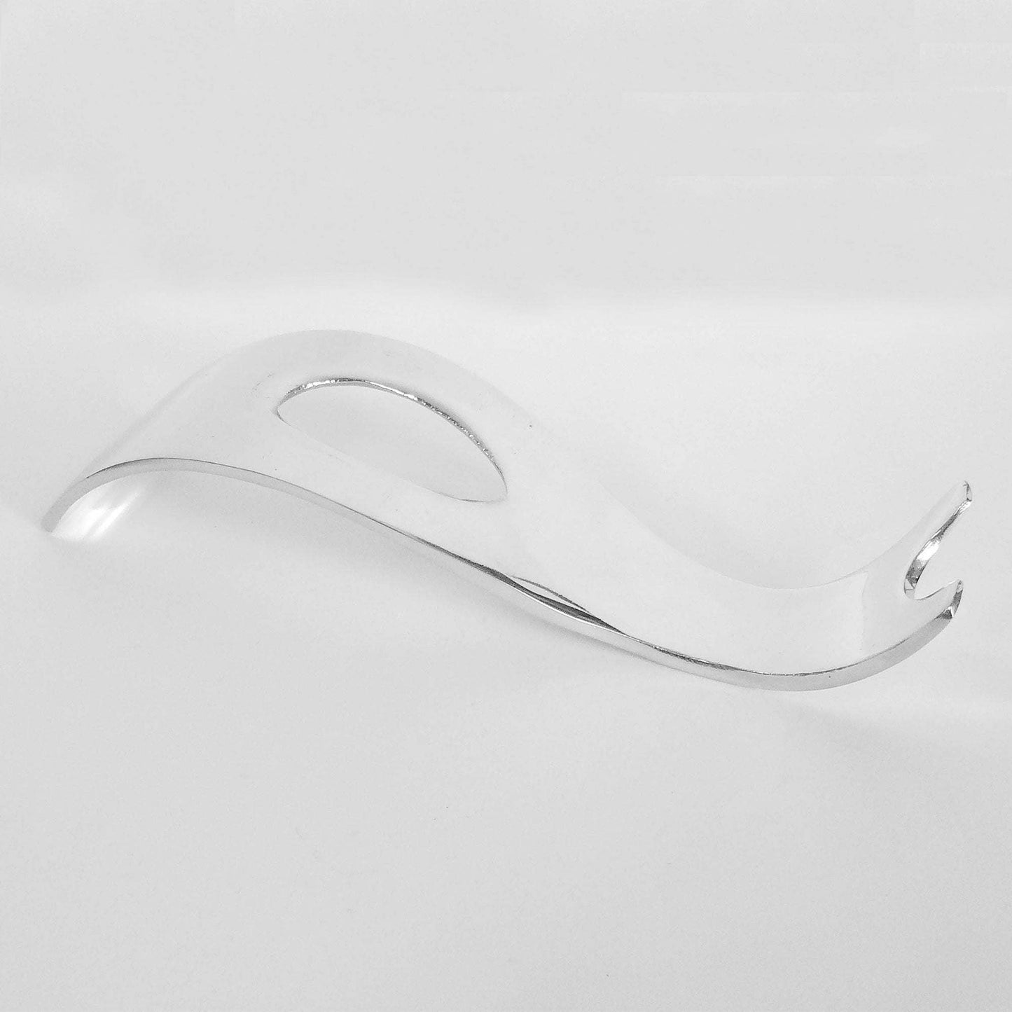 Curved chrome bottle holder, sculpted wave-shaped stand with open center