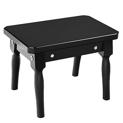 Black toy piano bench with padded top and four legs