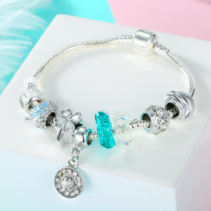 Silver charm bracelet with blue crystal glass beads and round rhinestone heart charm