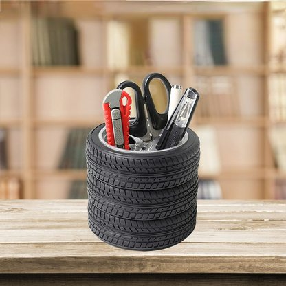 Black tire tread pen holder with pens and red-handled scissors insert