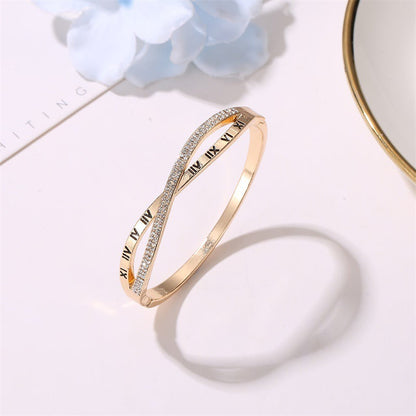 Gold-tone roman numeral bracelet bangle with rhinestone border and etched Roman numeral markings
