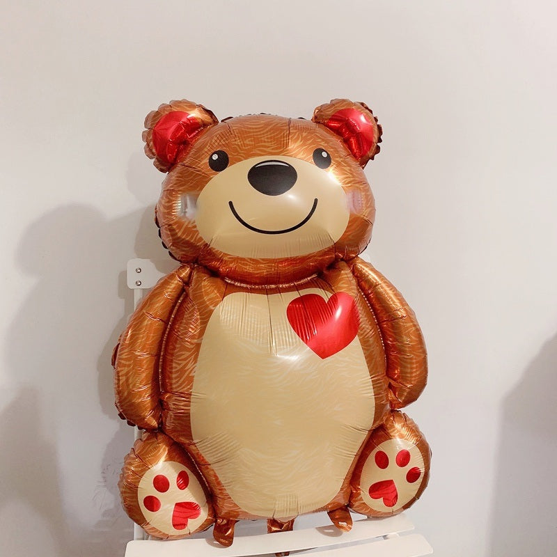 Brown bear foil balloon with red heart on white belly and red paw-print feet