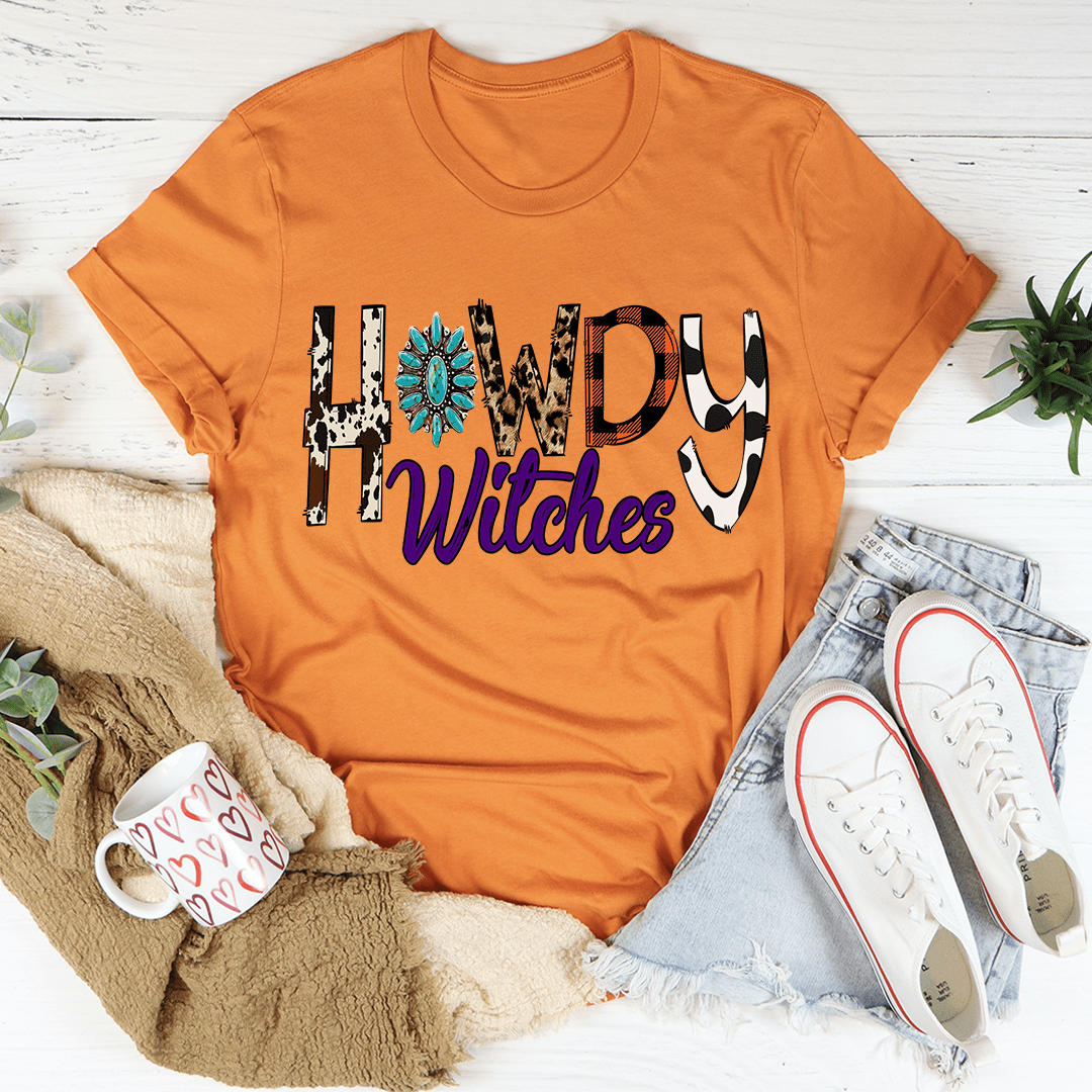 Burnt orange crewneck T-shirt with bold “Howdy Witches” Halloween graphic front.