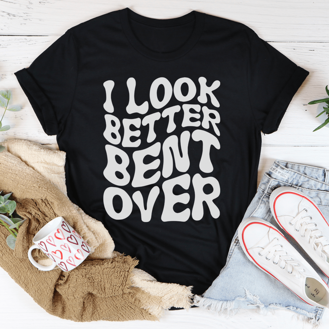 Black crewneck graphic t-shirt with "I LOOK BETTER BENT OVER" slogan print