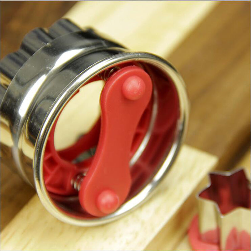 Red pastry cutter insert in a stainless ring, showing inner cutout shape