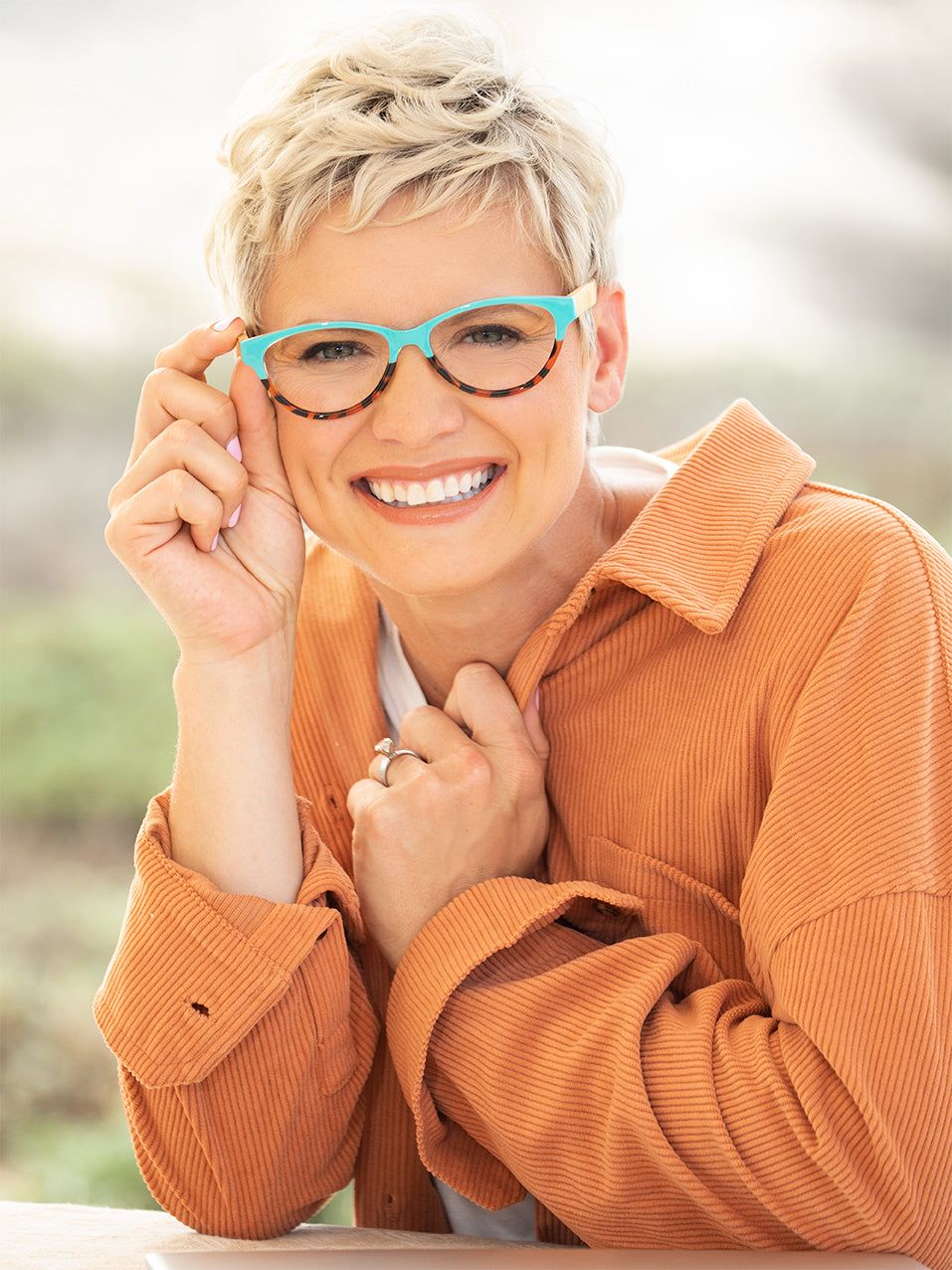 Woman wearing LUCIA Readers teal eyeglasses with clear lenses