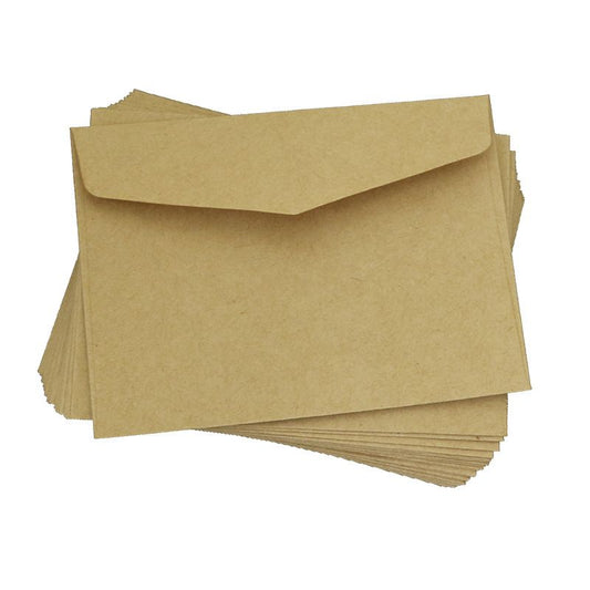 Set of mini paper card envelopes in kraft brown, stacked with flap closures
