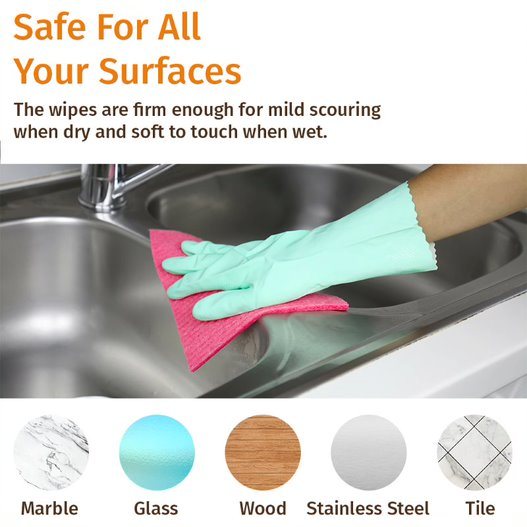 Hand wiping a stainless sink with a teal and pink multi-surface cleaning cloth