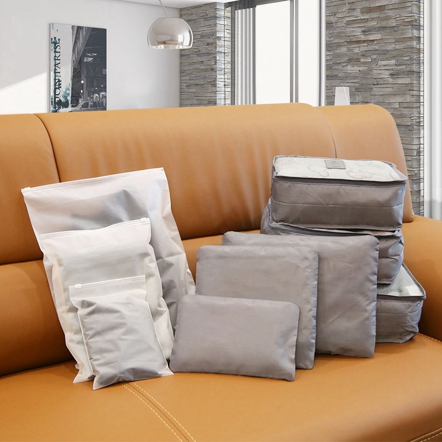 Gray packing cubes and organizers folded in a travel luggage storage set