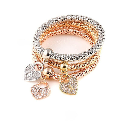 Multicolor rhinestone bracelet with four heart charms and mixed gold-silver links