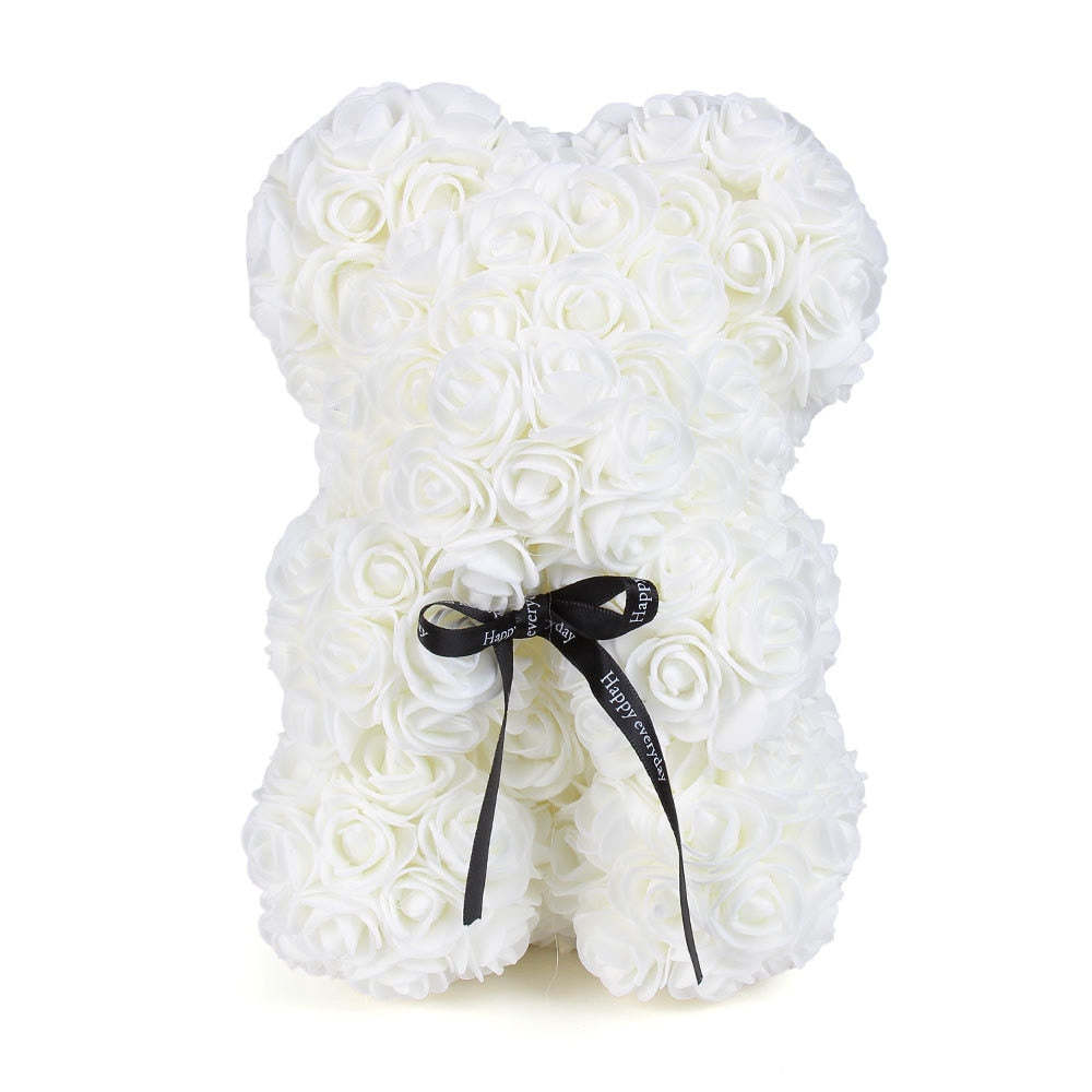 White rose teddy bear with layered rose petals and a black ribbon bow