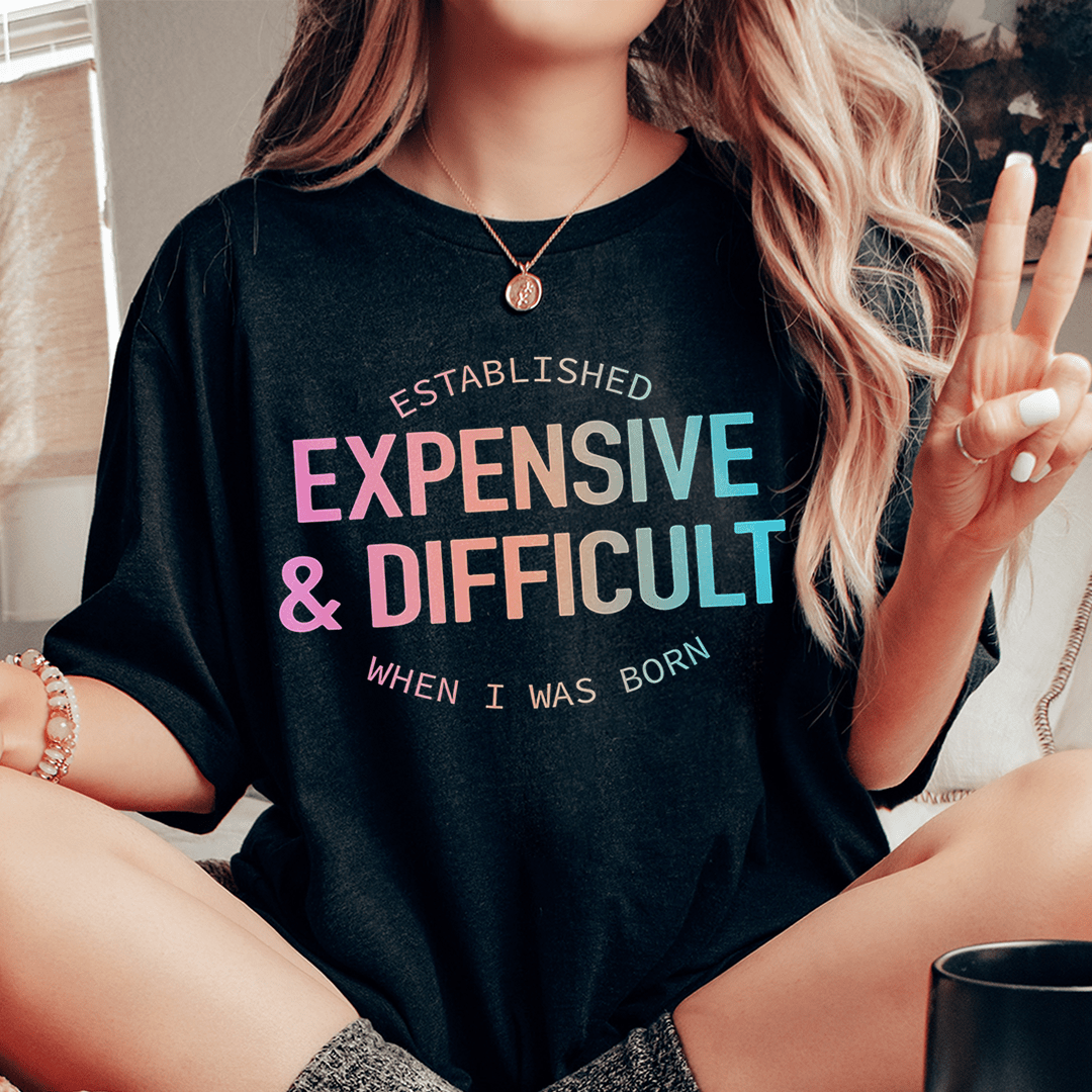 Black crew-neck T-shirt with multicolor 'EXPENSIVE & DIFFICULT' graphic