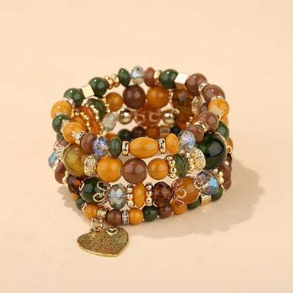 Heart charm bead layered bracelet set with green and gold-tone beads and heart pendant