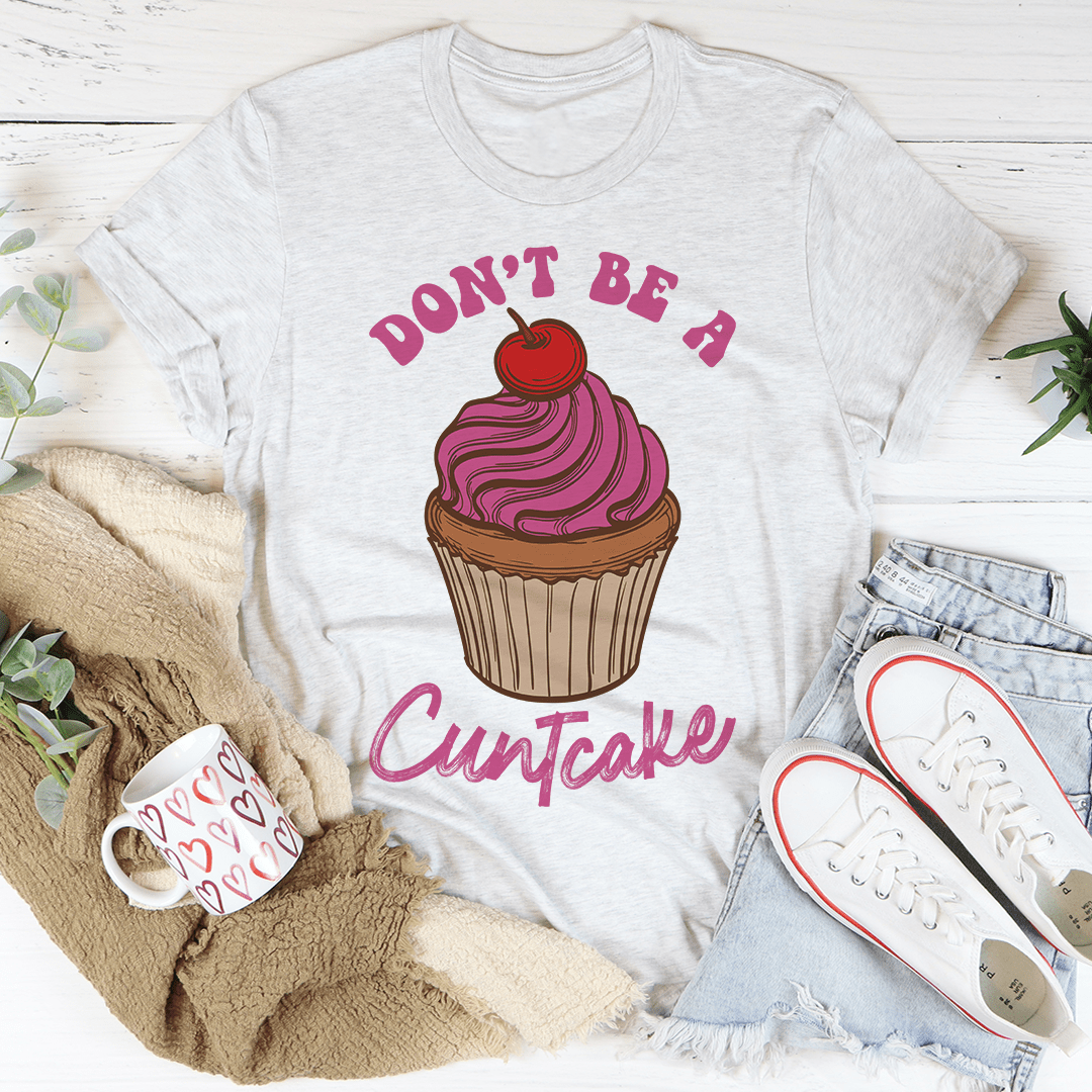 Light gray T-shirt with cupcake graphic and slogan text, crew neck short sleeves